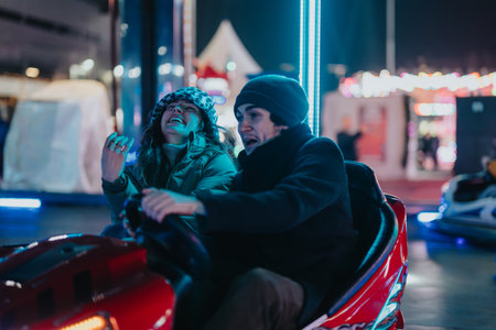 Couple Enjoying a Fun Ride on a Bumper Car at Night