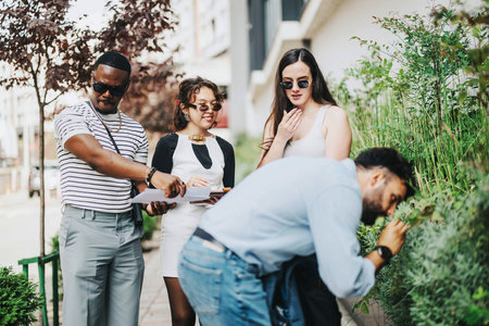 Young people collaborating outdoors on creative business projectの写真素材