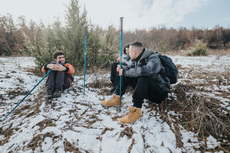 Young people enjoying a winter hiking adventure in a scenic snowy landscape