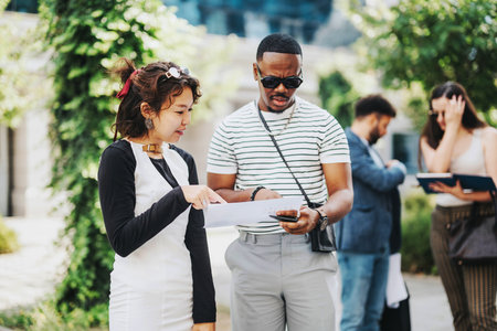 Casual business meeting outdoors with diverse professionals discussing plans