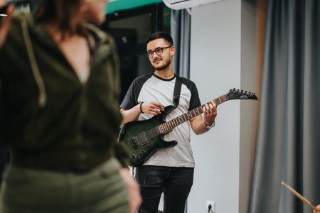 Musicians rehearsing together with electric guitar in a modern studio settingの写真素材
