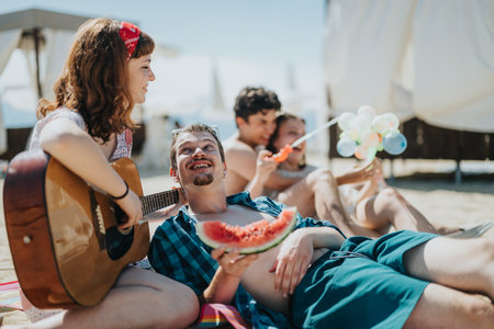 Group of Friends Relaxing on the Beach Enjoying Music and Summer Funの写真素材