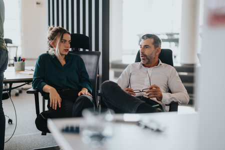 Business employees discussing ideas in a modern office settingの写真素材