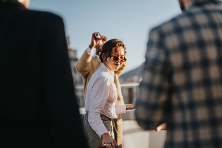 Diverse business colleagues celebrating on a rooftop at sunset