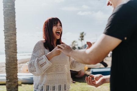 Happy individuals engaged in lighthearted conversation on a sunny day outdoorsの写真素材