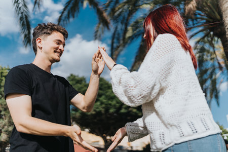 Couple sharing a joyful moment outdoors under palm trees on a sunny day