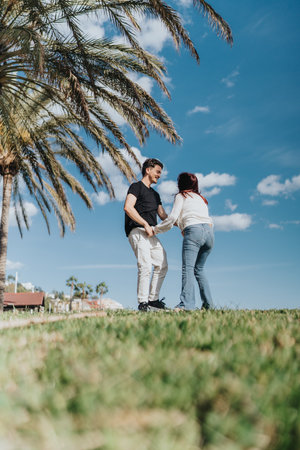 Young couple enjoying a sunny day outdoors near palm trees in Spain