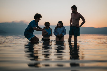 Group of friends enjoying time together in the calm waters at sunset