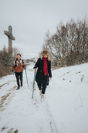 Friends enjoying a winter hike together in a snowy landscapeの写真素材