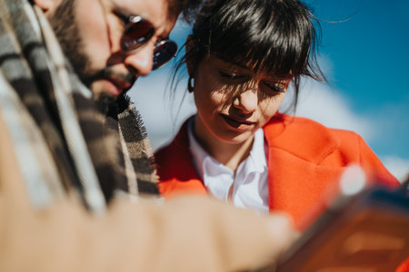 Young entrepreneurs collaborating outdoors on a sunny dayの写真素材