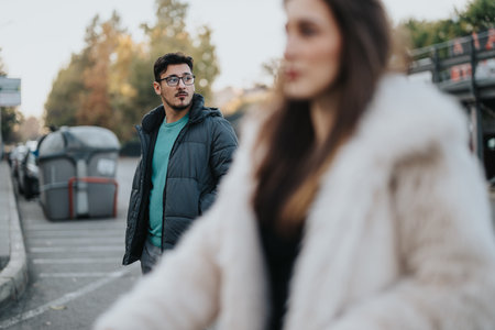 Man Looking at a Woman in an Urban Street Settingの写真素材