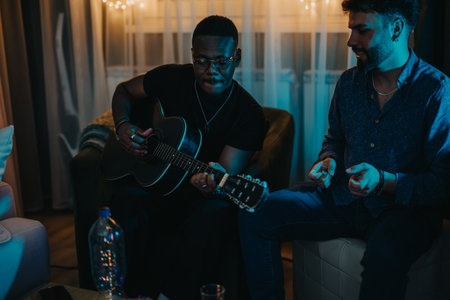Two Friends Enjoying Music Together in a Cozy Indoor Settingの写真素材
