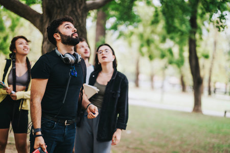 Young multicultural students collaborating on a school project in the parkの写真素材