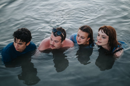 Group of young friends enjoying time together in the water outdoors