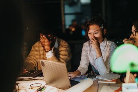 Diverse team of business people working late on a project deadlineの写真素材