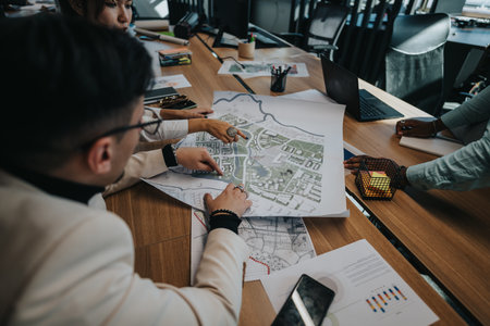 Business professionals collaborating on urban planning project in modern office