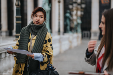 Two individuals discussing and collaborating outdoors in a public settingの写真素材