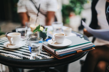 Cafe meeting with diverse group discussing projects and ideasの写真素材