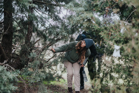 Young adventurers exploring a dense greenery landscape in a forest settingの写真素材