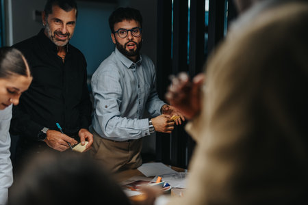 Diverse team brainstorming project ideas during evening meetingの写真素材