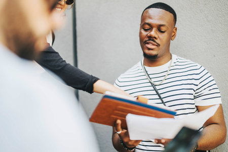 Business team discussing documents during an outdoor meeting