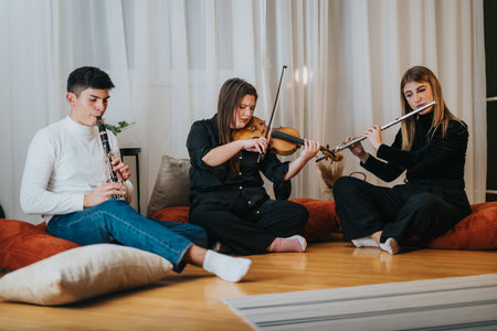 Group of musicians playing clarinet, violin, and flute during a cozy indoor sessionの写真素材