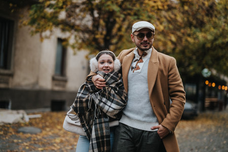 Young couple enjoying a walk in autumn city park togetherの写真素材