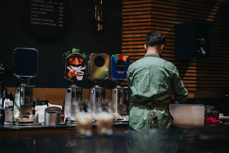 Barista preparing drinks in a cozy coffee shop environmentの写真素材
