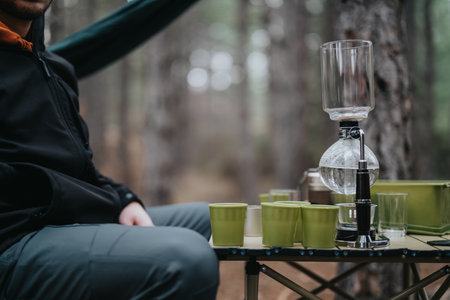 Outdoor setup for a casual winter picnic featuring unique brewers and green cupsの写真素材