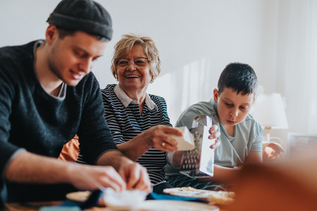 Family enjoying time together while preparing food in a cozy home environmentの写真素材