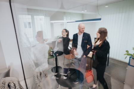 Casual interaction among colleagues in a modern workspaceの写真素材