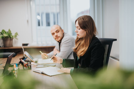 Two Colleagues Engaged in a Focused Meeting at Their Office Workspace