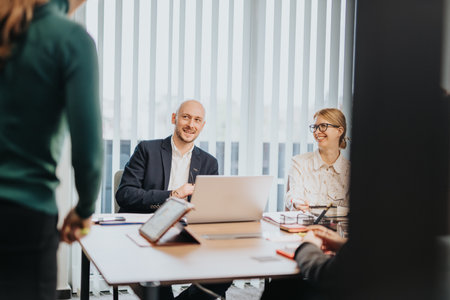 Professional team discussing ideas in a modern office settingの写真素材