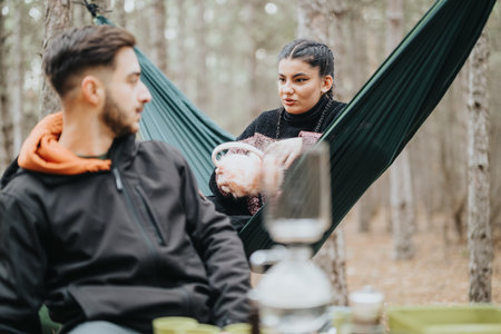 Friends Enjoying a Cozy Outdoor Picnic Together in Wintertimeの写真素材