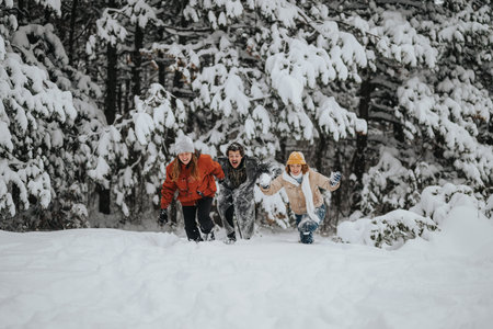 Three friends enjoying playful moments in a snowy forest setting