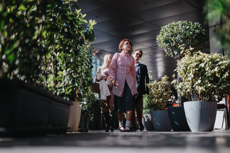 Business people walking through a lush urban courtyard