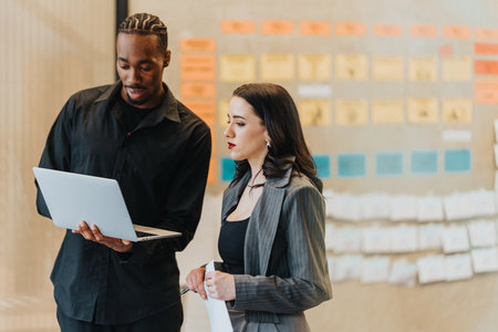 Two businesspeople collaborating during a project in a modern office environment