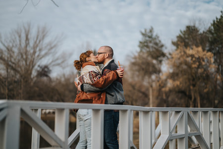 Couple enjoying a romantic moment on a scenic walkway in autumnの写真素材