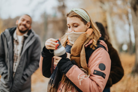 Group of Friends Enjoying Chilly Weather Outdoors During Fall Seasonの写真素材