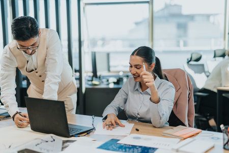 Business team collaborating in modern office space on projectの写真素材