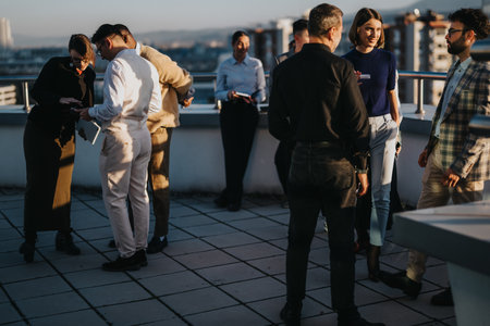 Diverse brainstorming session on highrise balcony at sunsetの写真素材