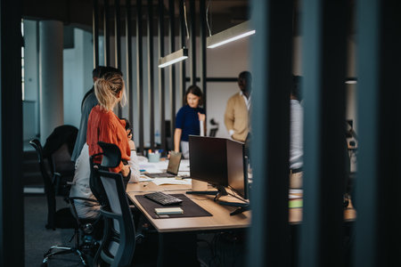 Multicultural business team collaborating in modern office environmentの写真素材