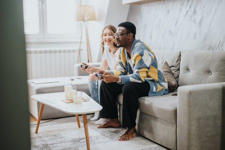 Diverse couple enjoying a video gaming session together at home in a cozy living room setting