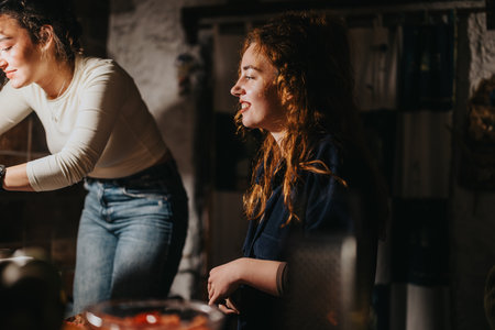 Two women enjoying their time together in a warmly-lit rustic kitchen