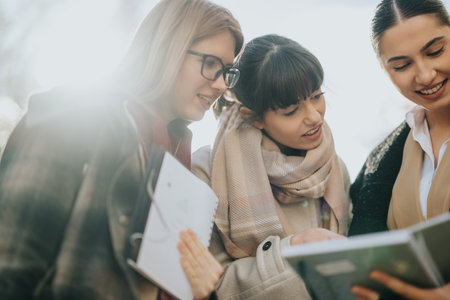 Group of women collaborating outdoors during a professional meetingの写真素材
