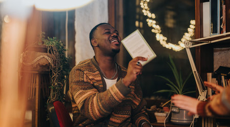 A Happy Man Enjoying Quality Time Indoors During a Cozy Eveningの写真素材