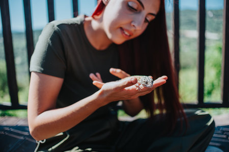Young girl enjoys playful moment with friendly lizard outdoors, embracing nature and discovery