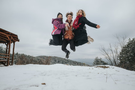 Three friends jumping together outdoors in a snowy winter setting enjoying an adventure