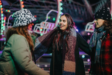 Group of friends enjoying the winter holiday season at a fairgroundの写真素材