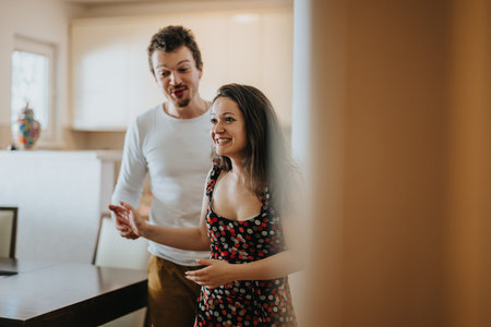 Playful couple enjoying a light moment in cozy home settingの写真素材